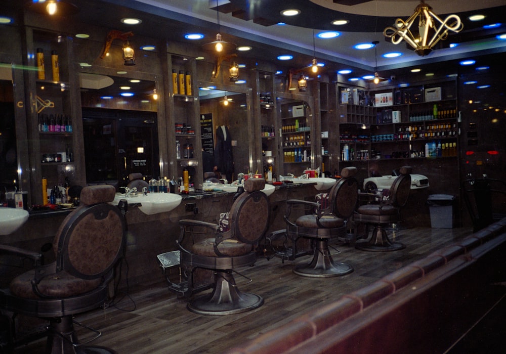 The interior of a barbershop with a row of leather barber chairs